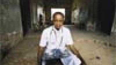 A man sitting on a bench.