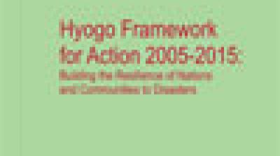 Blurry cover image with the text: "Hyogo Framework for Action 2005-2015: Building the Resilience of Nations and Communities to Disasters" on a green background.
