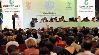 A large audience listens to speakers and panelists at the United Nations Climate Change Conference 2011 (COP17/CMP7) in Durban, South Africa.