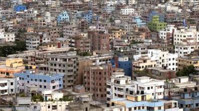 A dense urban area with many closely packed multi-story buildings of various colors, showing minimal green spaces.