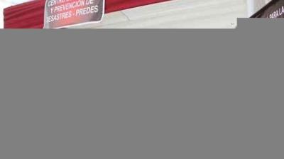 A red and white tent with a sign reading “Centro de Gestión y Prevención de Desastres – PREDDES.” The lower part of the image is partially obscured.