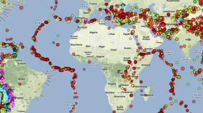 A world map displays clusters of colored dots marking earthquake locations and seismic activity zones across continents and oceans.