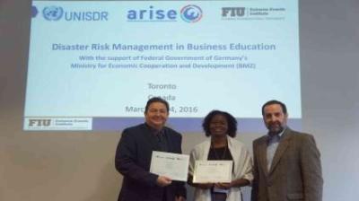 Three people stand in front of a screen displaying "Disaster Risk Management in Business Education" at an event in Toronto on March 24, 2016, holding certificates.