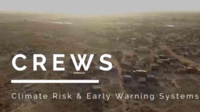 Aerial view of a rural area with scattered buildings. Text overlay reads "CREWS Climate Risk & Early Warning Systems.