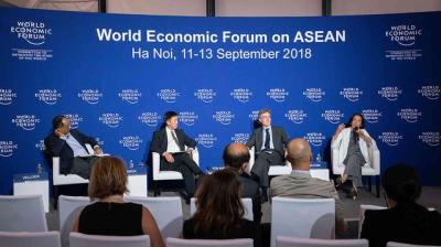 Four panelists speak on stage at the World Economic Forum on ASEAN in Hanoi, Vietnam, held from September 11-13, 2018, with attendees seated in the foreground.