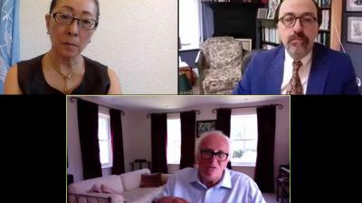 Three people participate in a video conference, each in separate home or office settings, with bookshelves and furniture visible in the background.